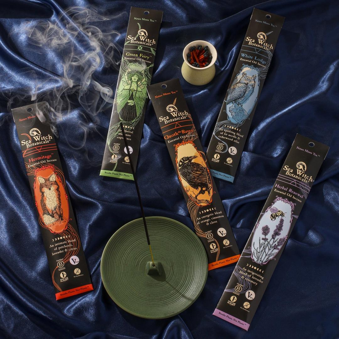 Incense sticks with packaging on a dark blue satin background