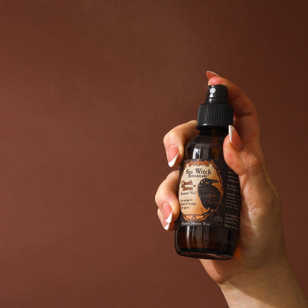 Hand holding a bottle against a brown background