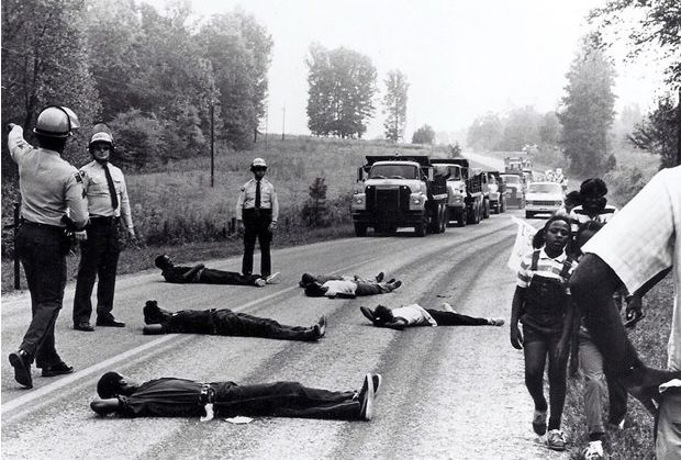 Citizens lay in the streets to protest toxic waste