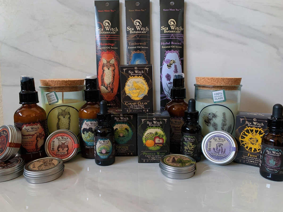 Collection of Taurus Season products on marble background including incense, soaps, candles, sprays, lip tints, lip balms, perfume tins, and oil droppers.