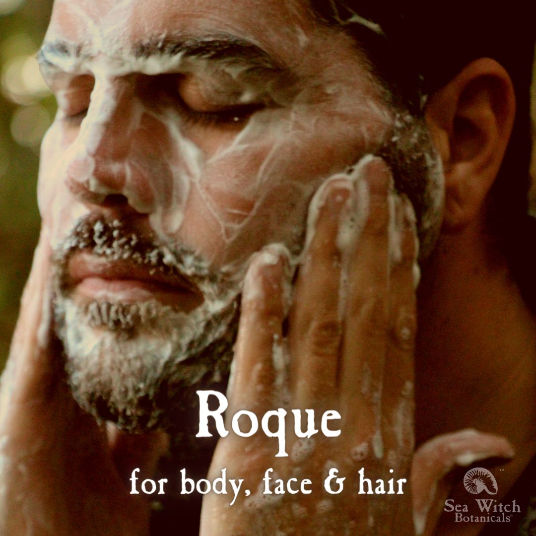 A man with a short dark beard washes his face with Roque grooming soap. Text reads "Roque: for body, face &amp; hair"