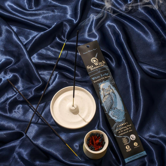 Incense sticks with a burner and packaging on blue fabric